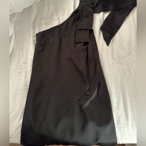 Black one shoulder dress. Bow on strap.